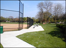 A concrete pathway extends from the parking to the team seating and spectator viewing areas at this park ball diamond