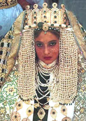 A photo of a Berber (Morocco) bride wearing an elaborate head dress.